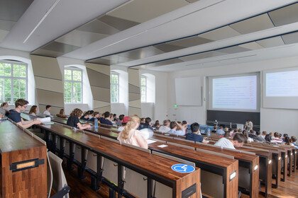 Studierende hören einem Vortrag zu.