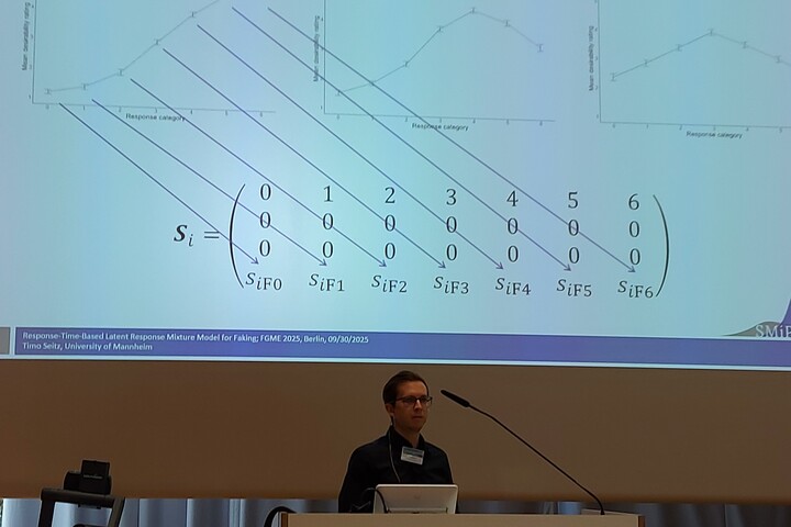 Researcher giving a talk at a conference