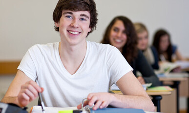 Student working on homework in classroom