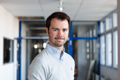Marc Philipp Janson wearing a white shirt in front of a glass door.