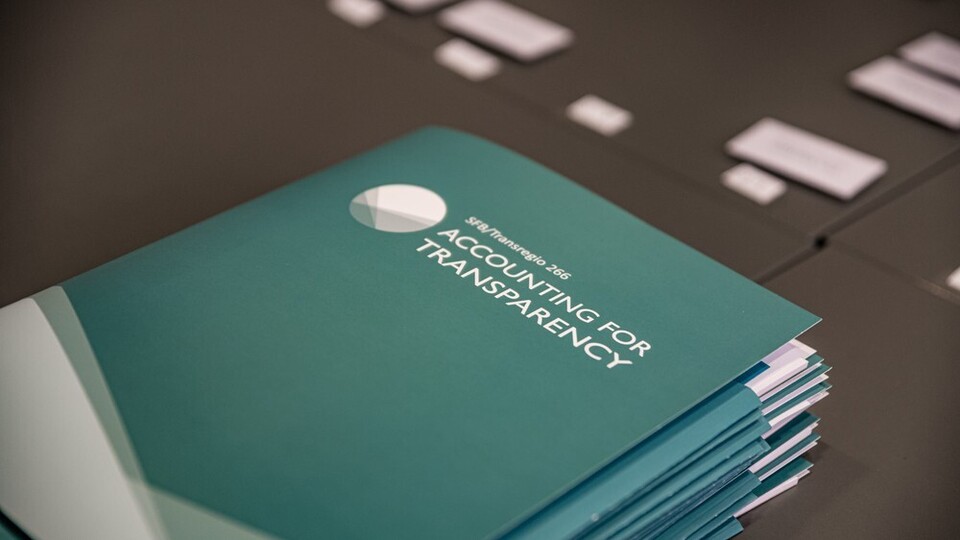 Stapel dunkelgrüner Ordner mit weißem Aufdruck und Logo von Accounting for Transparency