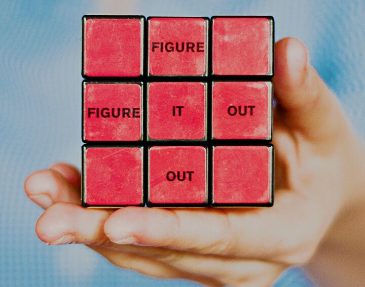 A red cube with the inscription: Figure it out.