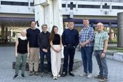 Group of researchers in front of the School of Social Sciences building.