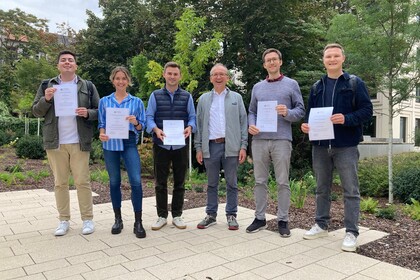 GESS award winners standing in the yard, holding their certificates. From left to right: Pablo Zarate Cisternas, Klara Müller, Clemens Lauer, Prof. Thomas Gschwend, Sven Vahlpahl and Johannes Gaul.