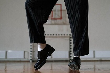 Zwei tanzende Beine mit schwarzer Hose und schwarzen Schuhen sind zu sehen. Unten rechts steht: IFS. Institut für Sport. Universität Mannheim.